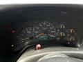 Dashboard of a 2006 GMC C5000 showing speedometer RPM dial fuel gauge and warning lights
