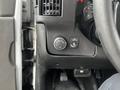 Interior controls of a 2018 Chevrolet Express including a dial for lights and a button to deactivate the cruise control