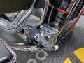 Close-up of the chrome engine components of a 2024 Harley Davidson Fat Boy showcasing intricate details and polished metal surfaces