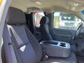 Interior of a 2013 Chevrolet Silverado 1500 featuring two front seats and a center console with storage space