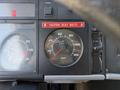Dashboard of a 1994 Volvo FE 42 showing speedometer and tachometer with a seat belt reminder indicator in red