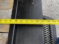 A 2021 Ford E-450 with a measuring tape extending over a surface showing measurements in inches