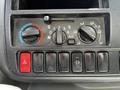 Control panel of a 2018 Hino 195 featuring HVAC controls and buttons for hazard lights and air circulation settings