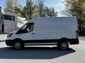 2021 Ford Transit van in white with a high roof and sliding side door parked on a pavement