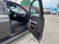 A 2016 Chevrolet Tahoe with the front driver's side door open revealing the interior featuring a black dashboard and seating