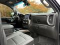 Interior view of a 2022 GMC Sierra 3500HD showing leather seating a central console and touchscreen display with climate controls