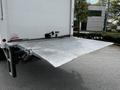 A 2020 Hino 338 truck with a lowered aluminum liftgate extending out from the back of the vehicle