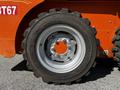 A close-up of a tire from a 2017 Gehl R105 heavy equipment machine with a gray rim and visible tread pattern