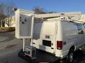 A 2007 Ford Econoline van equipped with an aerial work platform mounted on the roof