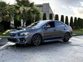 A 2021 Subaru WRX in gray color parked on a paved surface with sleek lines sporty design and distinctive front grille