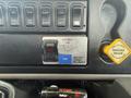 Close-up of the control panel inside a 2017 International 4300 featuring various switches and buttons including a PTO switch and parking brake control