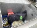 A 2009 Ford Econoline engine compartment containing various tools and equipment including a red toolbox and a black cloth