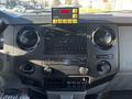 Interior dashboard of a 2011 Ford F-350 SD featuring audio controls climate controls and a GPS device mounted on top