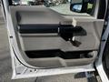 The image shows the interior door panel of a 2018 Ford F-550 featuring a gray and black design with a handle and a window control mechanism