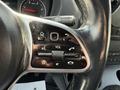 Close-up of the steering wheel controls of a 2019 Mercedes-Benz Sprinter with buttons for volume phone and other functions