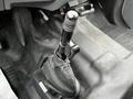 Black gear shift lever with a textured grip positioned in the cabin of a 2013 Ford F-650
