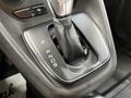 Gear shifter of a 2016 Ford Transit Connect with a leather cover showing the letters P R N D S