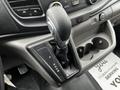 A close-up view of the gear shift in a 2021 Ford Transit featuring a leather-wrapped handle and gear indicator with the options P R N D M