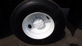 A close-up of a white truck wheel featuring a multi-stud hub and a Goodyear G622 RSD tire with a textured black sidewall