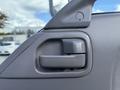 A close-up view of the door handle on the driver's side of a 2007 GMC W5500 18 Foot Cube Van