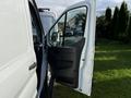 A white 2020 Ford Transit van with the driver's door open revealing the interior features and controls