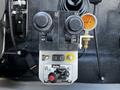 Control panel of a 2017 International WorkStar 7600 featuring joystick levers for operation a gauge and a PTO switch