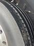 A close-up view of a tire from a 2006 E-One Typhoon showing tread patterns and wear with dirt particles visible on the surface