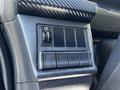 Dashboard controls of a 2021 Hino 338 featuring a series of buttons and a knob for various functions