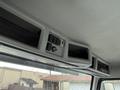 Interior overhead compartment of a 2012 Volvo VNL featuring storage bins and controls for lighting and ventilation
