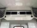 Interior view of a 2015 Ford Econoline showing air vents and overhead storage compartments