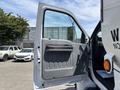 A 2015 Ford F-750 truck with its driver's side door open showcasing the interior door panel and handle