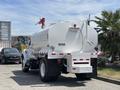 A 2015 Ford F-750 water truck with a large cylindrical tank and visible markings indicating it carries water