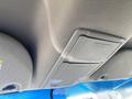 The interior ceiling of a 2013 Ford Expedition featuring a storage compartment and light controls