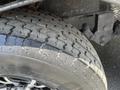 Close-up of a treaded tire from a 2013 Outdoor Wind River showing intricate patterns and textures on the rubber surface