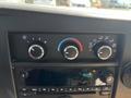 The dashboard controls of a 2017 Chevrolet Express showing temperature dials and a digital clock displaying 9:55