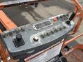 Control panel of a 2012 JLG 660SJ with various buttons and joystick used for operating the lift machine