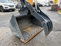 A 2022 Hyundai R55-9A excavator bucket with a worn edge and multiple attachment points visible