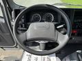 The image shows the steering wheel and dashboard of a 2016 Isuzu NQR with gauges and controls visible in the foreground