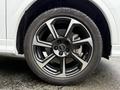 A close-up view of a 2024 Audi Q3 wheel featuring a five-spoke alloy design with a black and silver finish