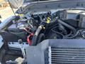 Close-up view of the engine compartment of a 2016 Ford F-250 SD highlighting various engine components including the battery hoses and radiator