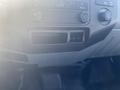 Dashboard of a 2014 Ford F-250 SD featuring climate control knobs and a storage compartment