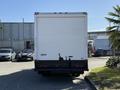 Rear view of a white 2013 Isuzu NPR box truck with a smooth surface and no visible graphics or markings