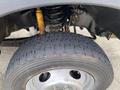 Close-up of a 2015 Ford F-550 tire and suspension system showing the tread pattern and coil spring assembly