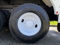 A close-up view of a black Bridgestone tire mounted on a white rim belonging to a 2008 International 7500 truck