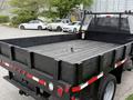 A 2020 Ford F-550 truck with a flatbed design featuring a wooden surface and a locking mechanism in the center