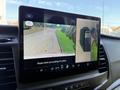Screen display in a 2022 Ford Transit showing a rearview camera view with guidelines and a side camera view of the vehicle's surroundings