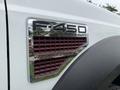 A close-up of the badge on a white 2008 Ford F-450 Super Duty showcasing the F-450 XL and V8 Power Stroke details