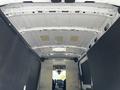Interior view of a 2022 Ford Transit showing the ceiling space with a white metal roof and gray walls