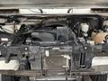 A 2012 Ford Econoline engine compartment showcasing various components including the radiator hoses and electrical connections