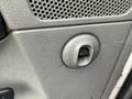 Close-up of a gray interior panel with a circular knob in the center located on a 2008 Dodge Ram 5500